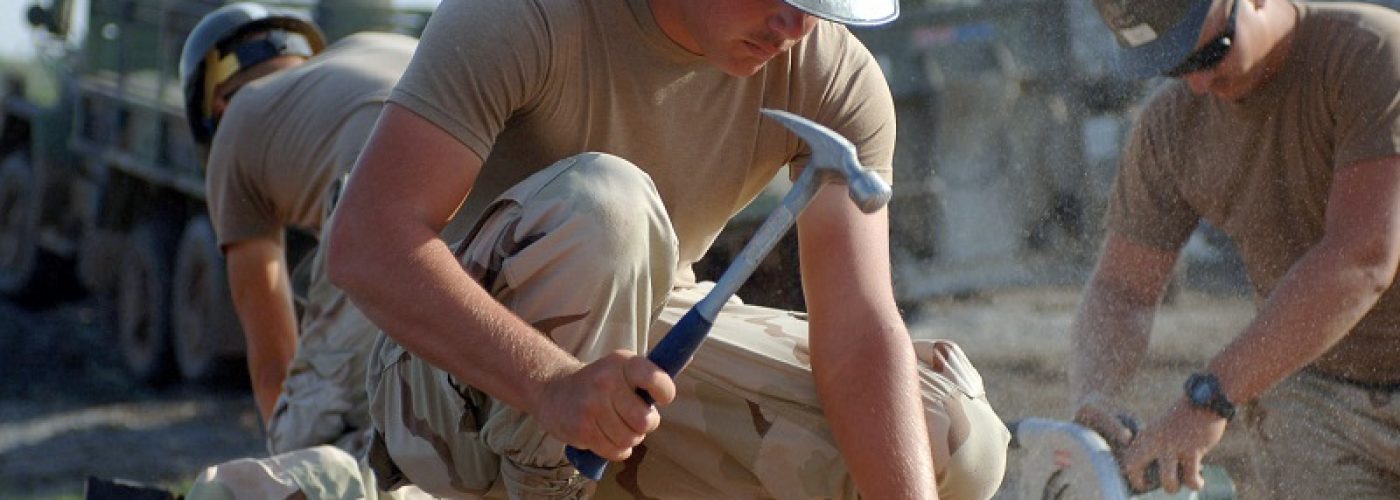 US_Navy_071006-N-1003P-001_Builder_Constructionman_Christopher_Lynch_of_Naval_Mobile_Construction_Battalion_NMCB_40_Det._Horn_of_Africa_HOA_hammers_nails_into_the_roof_for_