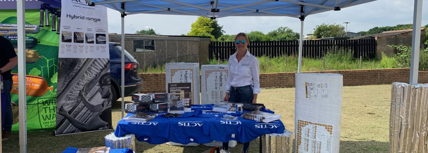 Actis regional sales director Jemma Harris encourages Jewson staff, customers and passers by to try their hand at installing Actis Hybris in a mock-up timber frame wall at the Jewson Monster Walk for charity
