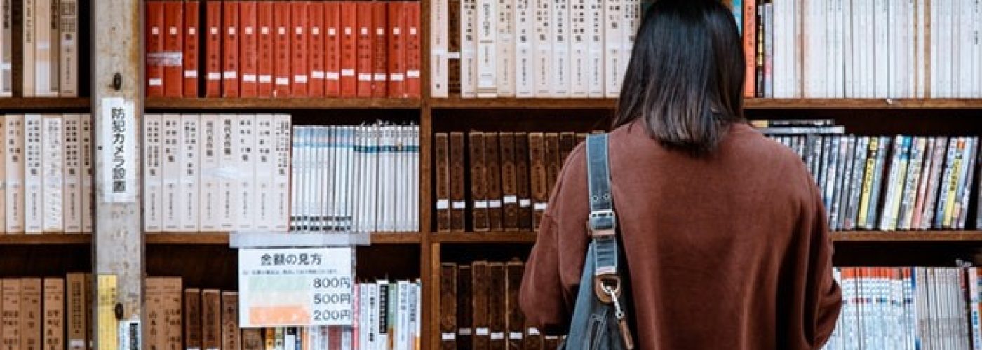 Image source - https://www.pexels.com/photo/woman-wearing-brown-shirt-carrying-black-leather-bag-on-front-of-library-books-1106468/